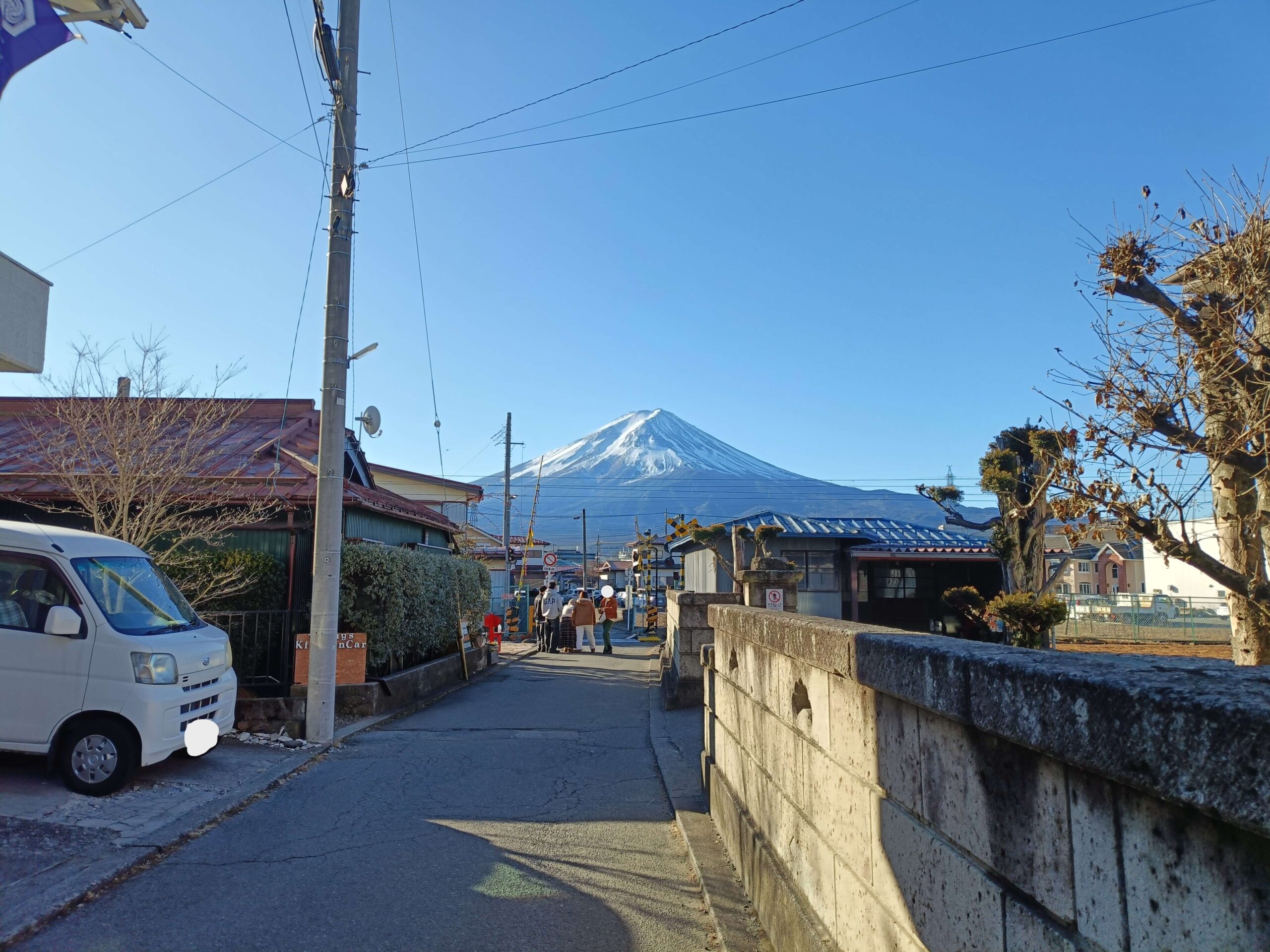 Tourists viewing Mount Fuji from observation deck with panoramic mountain views